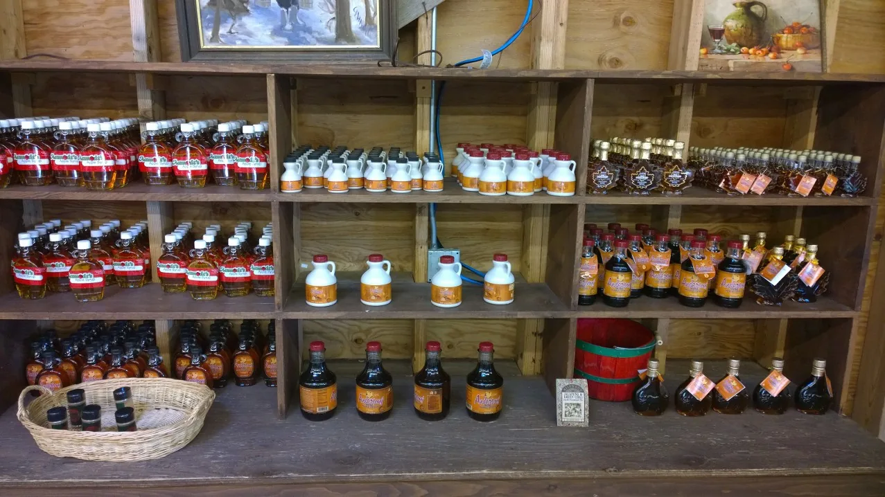 Aamodt's maple syrup, honey and pure maple syrup jugs on the pantry shelves