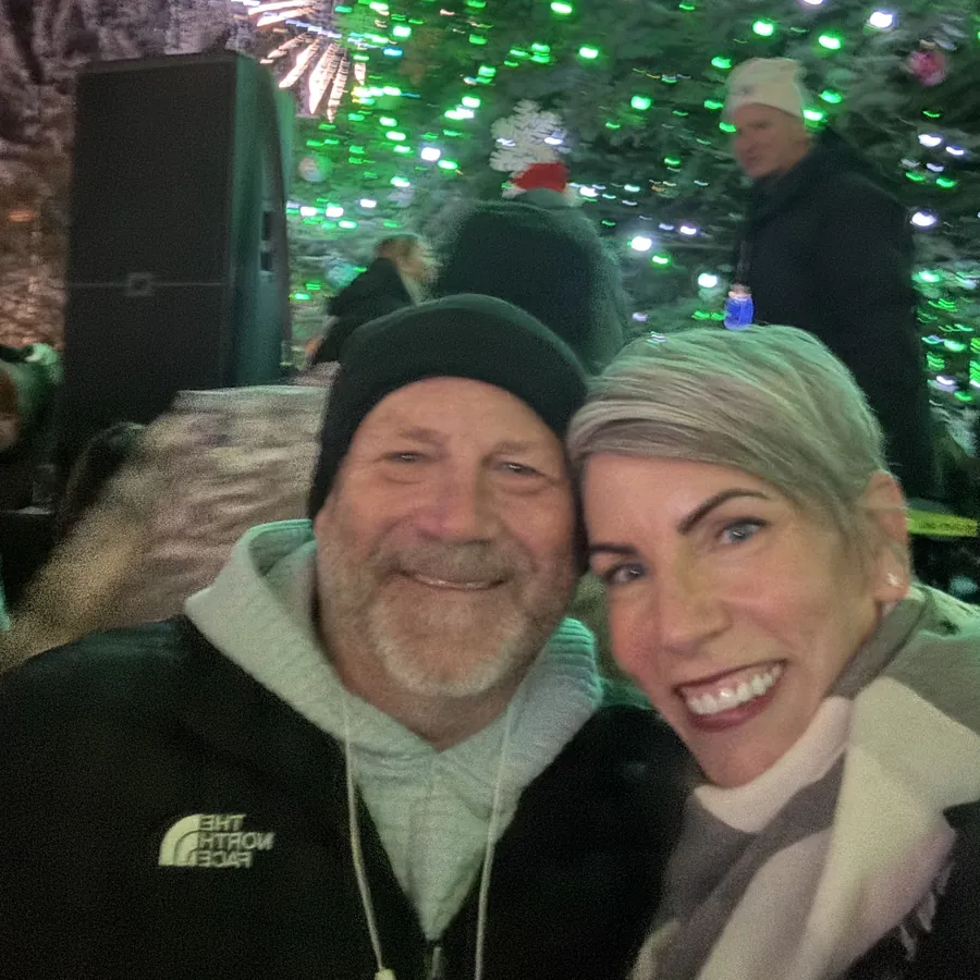 Chris and Billi Jo Aamodt in front of the lit 2025 Stillwater Christmas tree